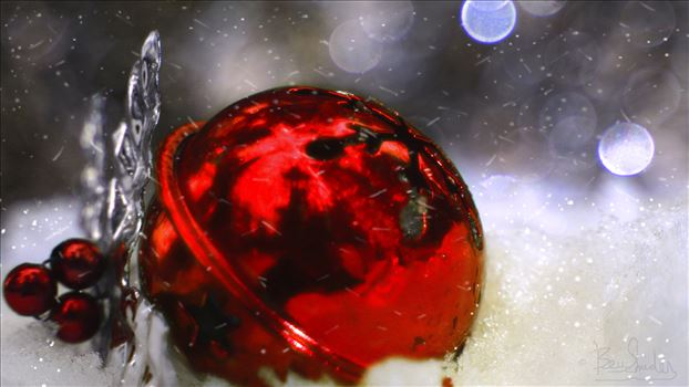 Bright Red Christmas Ball in the snow with bokeh background