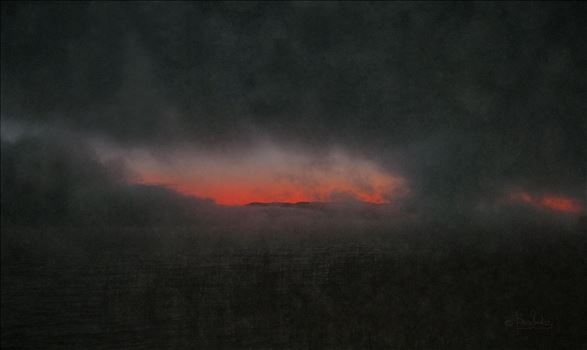 A stormy horizon peeks through ominous black clouds