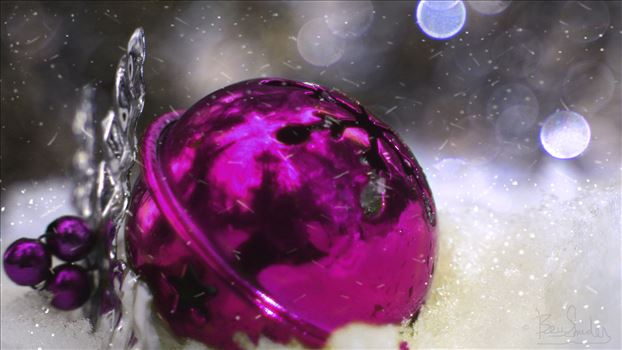 Fuschia Christmas Ball in the snow with bokeh background